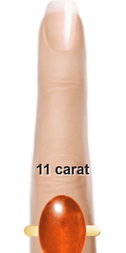 Orangey Red 11 carat cabochon-cut Sunstone on a ring and finger.