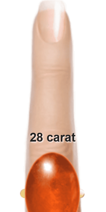 Orangey Red 28 carat cabochon-cut Sunstone on a ring and finger.